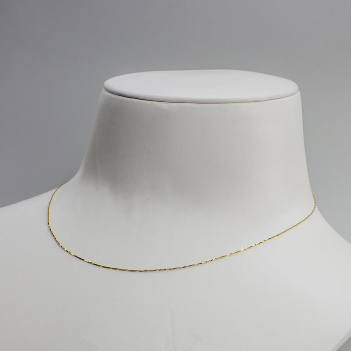 A box chain necklace displayed in a different angle.