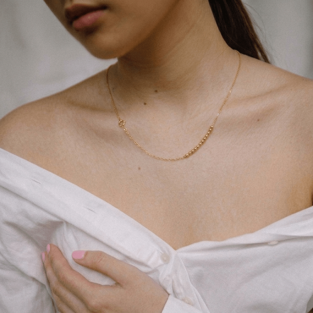 Golden Bead Accent Necklace – 18K Gold Asymmetrical Design - Delma Gold Jewelry